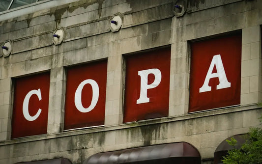The sign says copa on an old building.