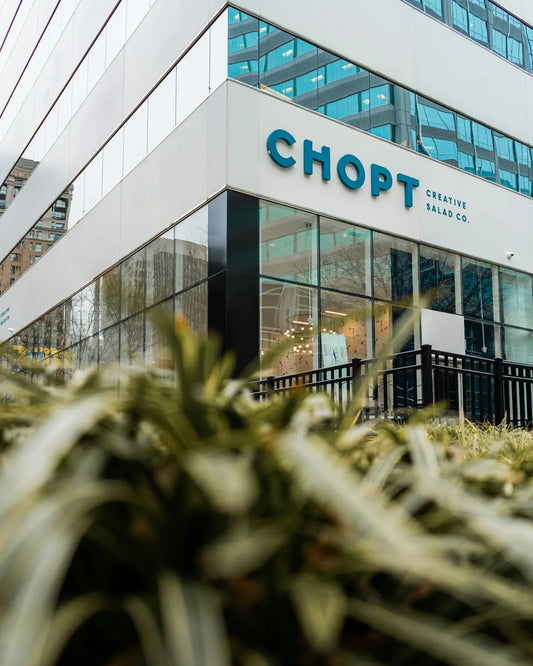 plants beside white Chopt building