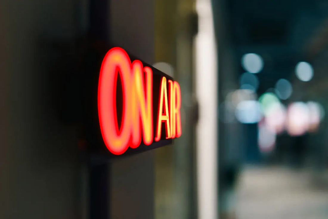 Red on air sign glowing in the dark