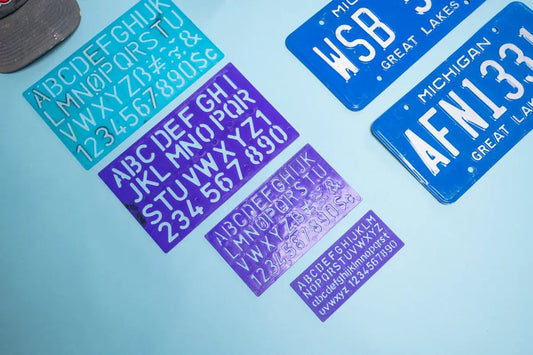 Sheets of alphabet and number stickers and license plates