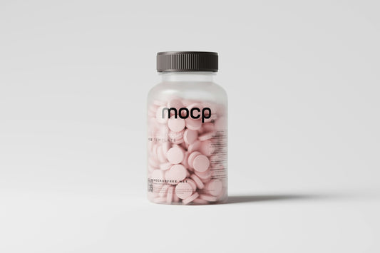 a bottle of pink pills sitting on top of a white table