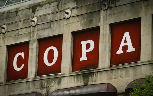 The sign says copa on an old building.