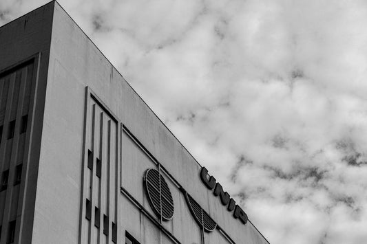 Modern building facade with circular windows against cloudy sky
