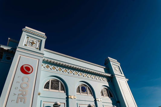 Pale blue building with ornate details against clear sky