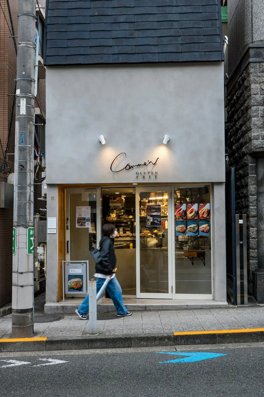 A person walks past a small cafe.