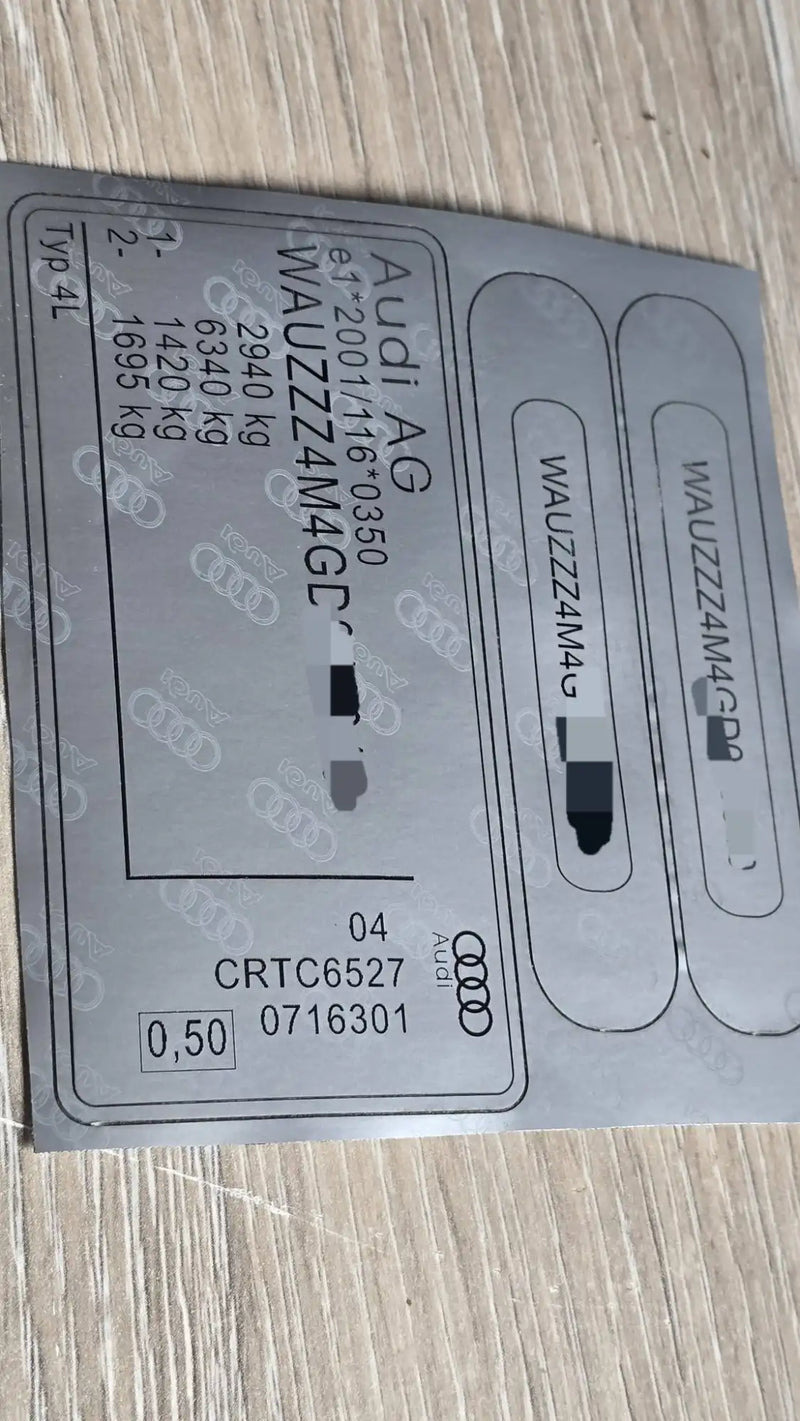 Gray audi ag vehicle identification label with black printed text and logos.