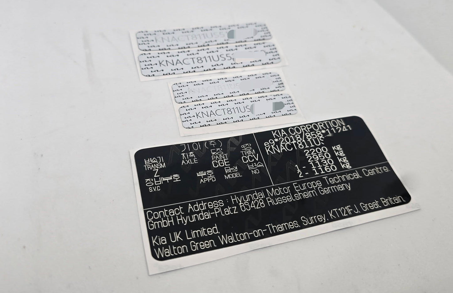 Order a complete Kia VIN replacement set including a door / B-pillar vehicle identification label, windscreen VIN label, and chassis VIN plate / engine bay data plate. Manufactured in the UK using durable automotive-grade materials for long-lasting identification.