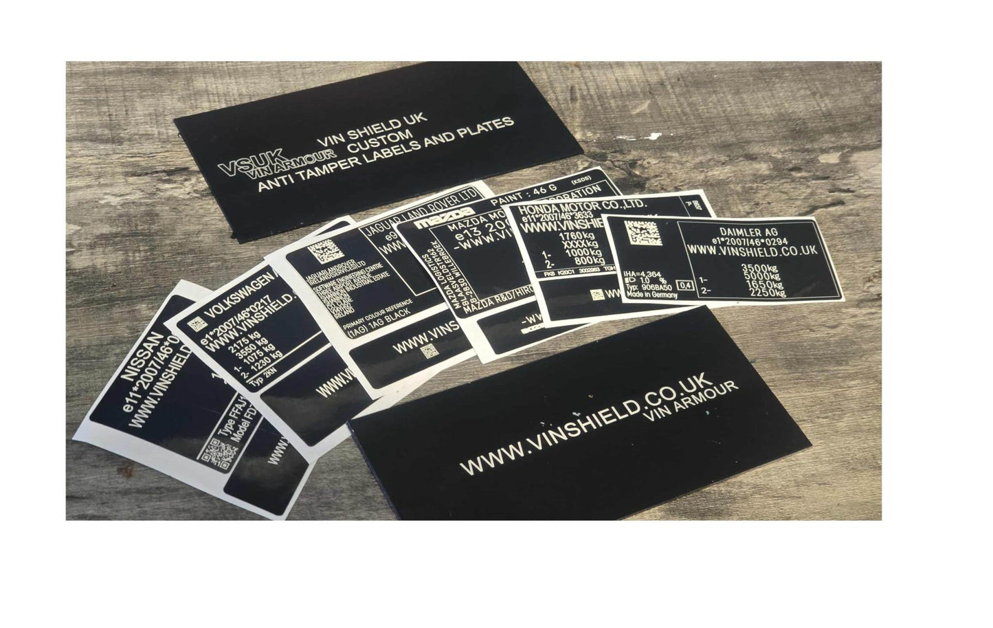 VINSHIELD UK black vin stickers vin plates chassis plates vin tags data tags data plates set on wooden surface